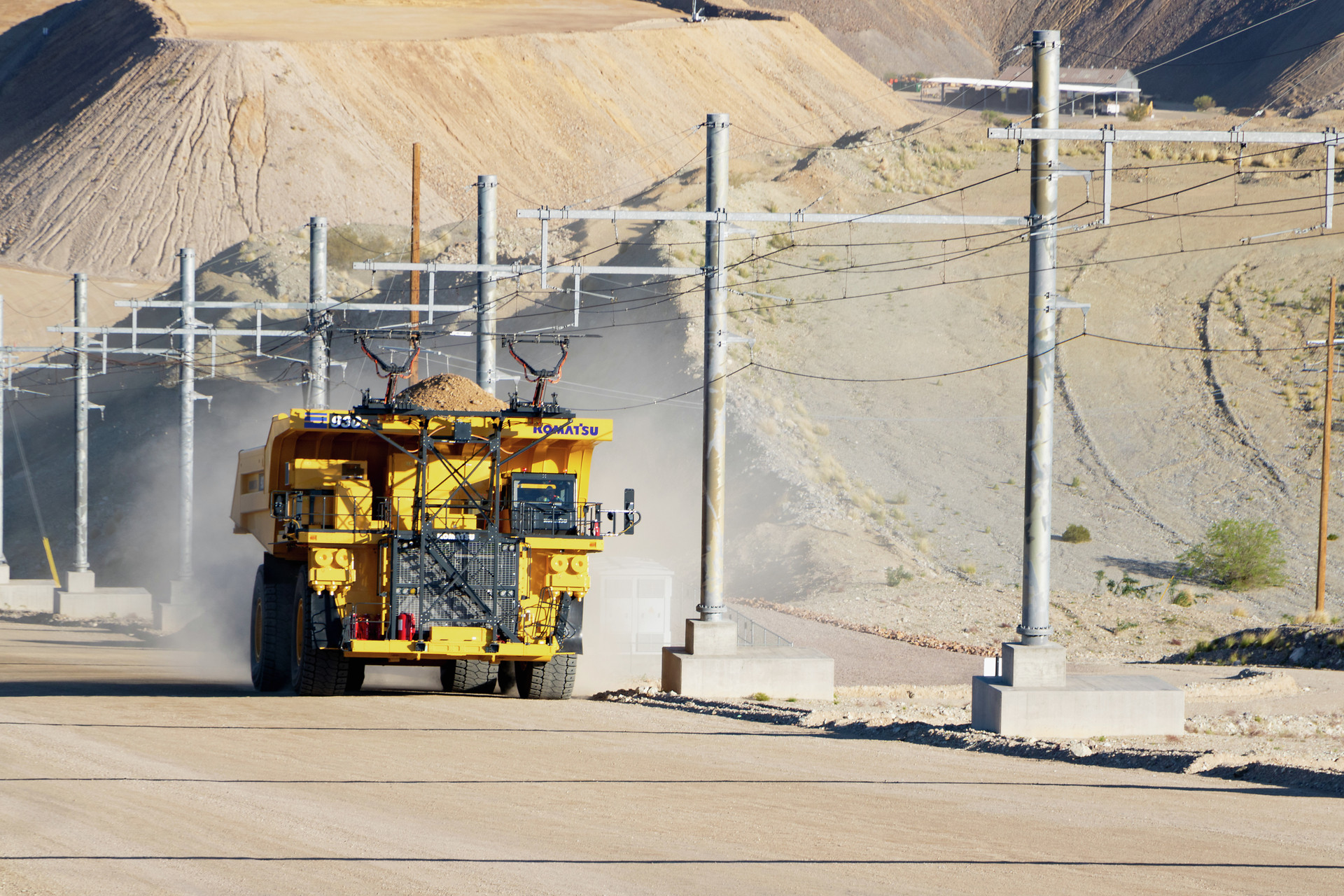 A Komatsu 930E Mining Truck in operation using trolley assist at a mine.