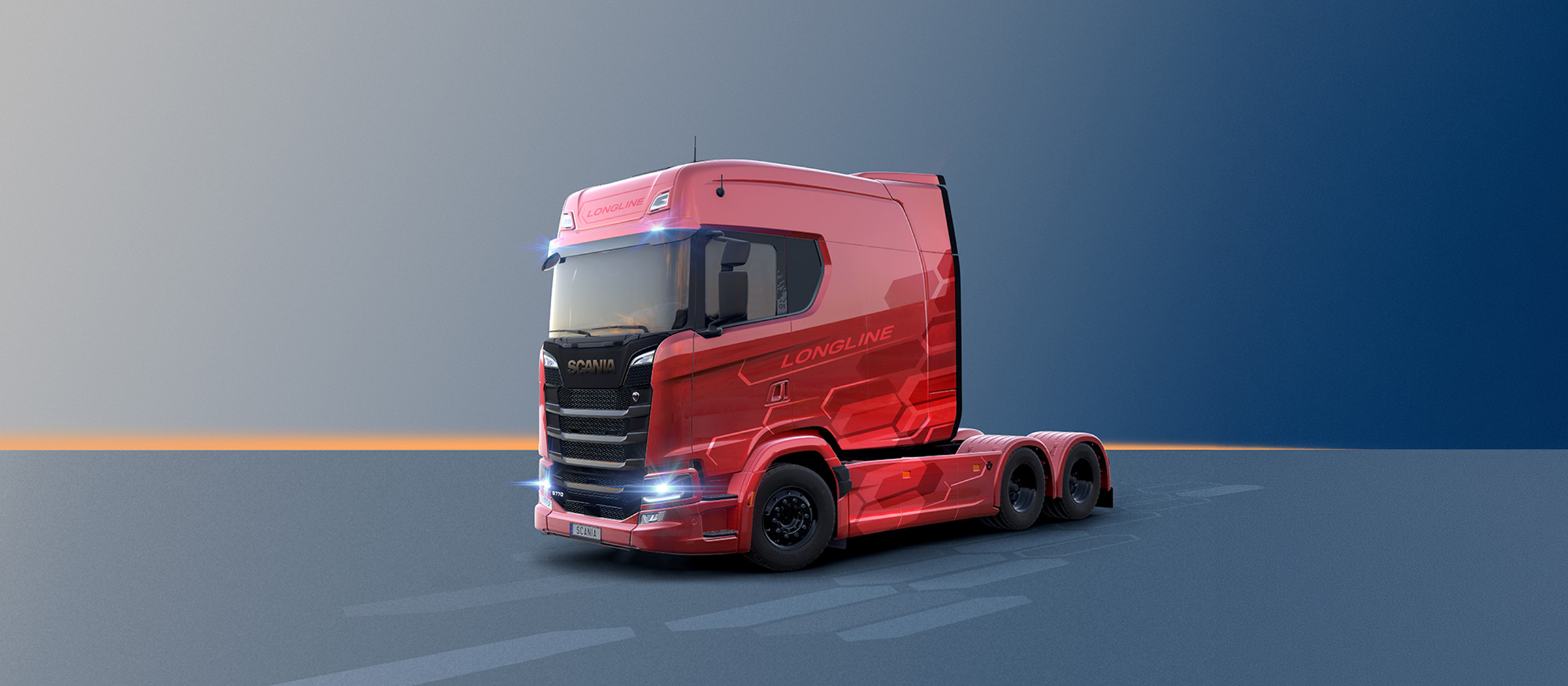 Side view of a Red Scania Longline truck featuring an extended cab design against a grey backdrop.