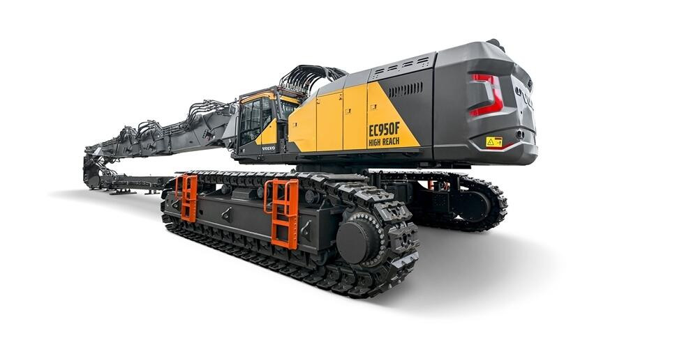 Volvo EC950 High Reach excavator shown from a low angle with extended boom and heavy-duty tracks against a white background.