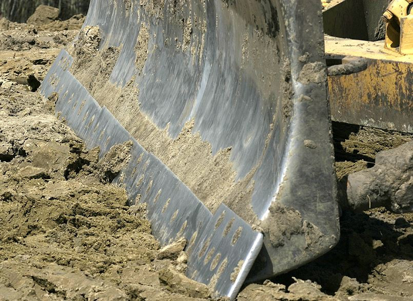 Close up view of a cutting blade edge on the ground.