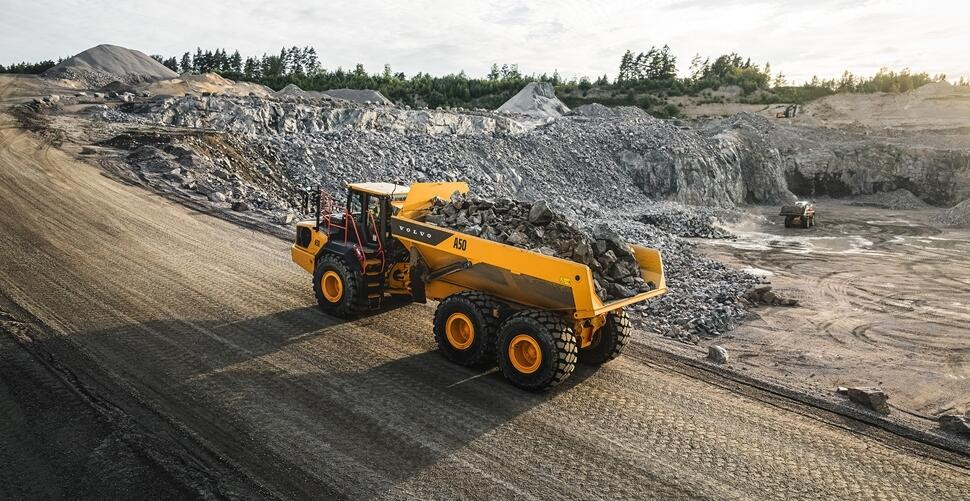 Volvo A50 articulated hauler with a full load of material operating on a construction site.