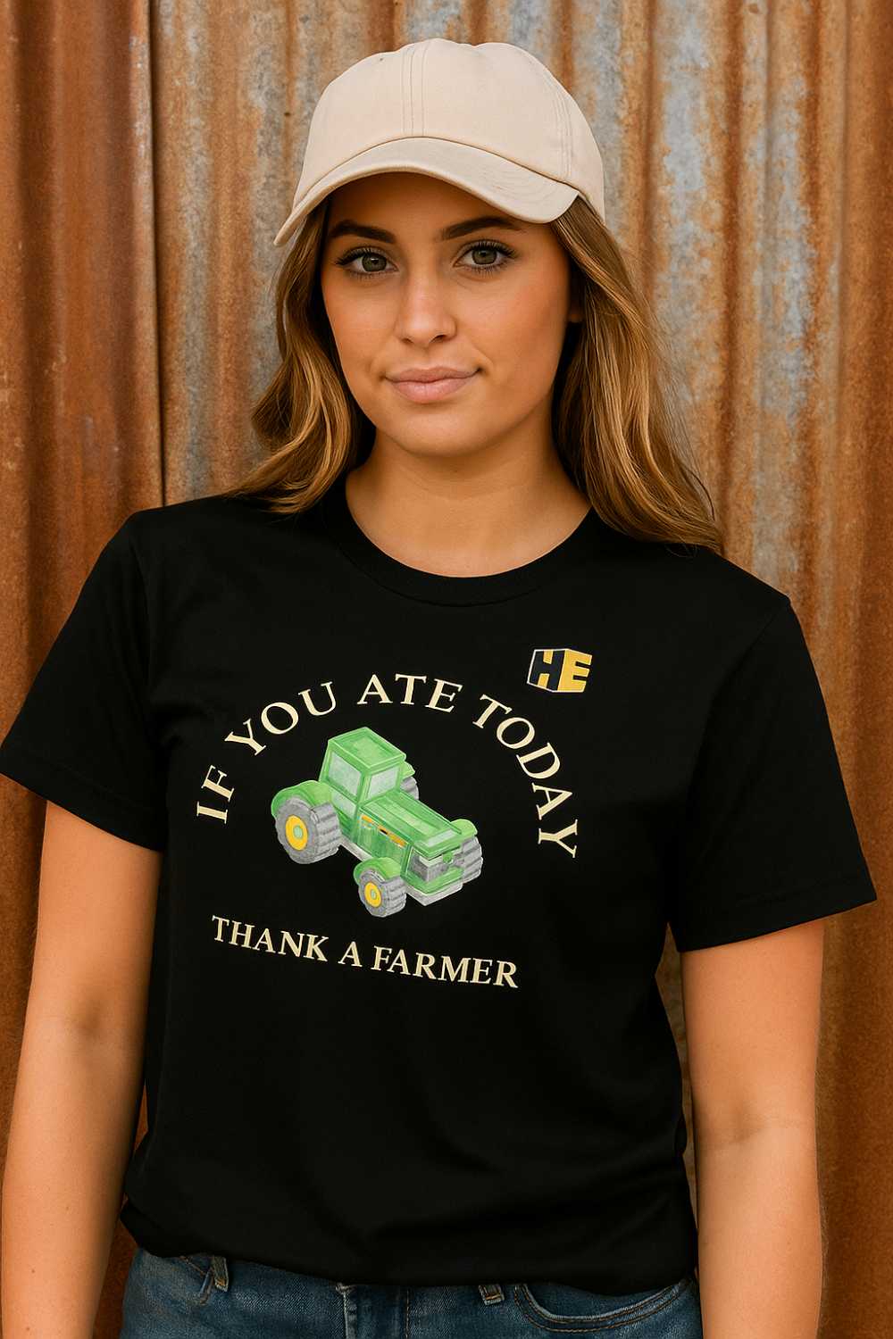 Women wearing a hat and black "Thank a Farmer" t-shirt with the HeavyEquipment.com logo on the front of the t-shirt.