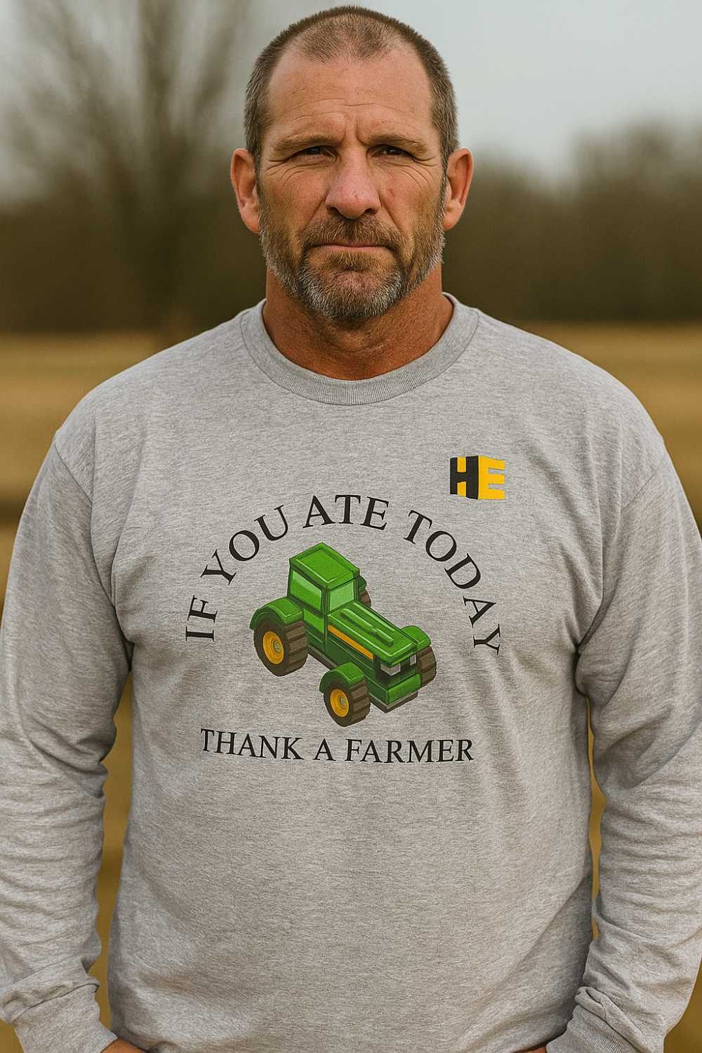 Man wearing a Grey "Thank a Farmer" long sleeve shirt with the HeavyEquipment.com logo on the front of the shirt.